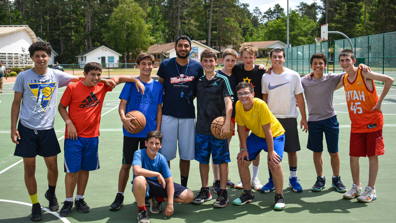 A group of campers on a basketball court.