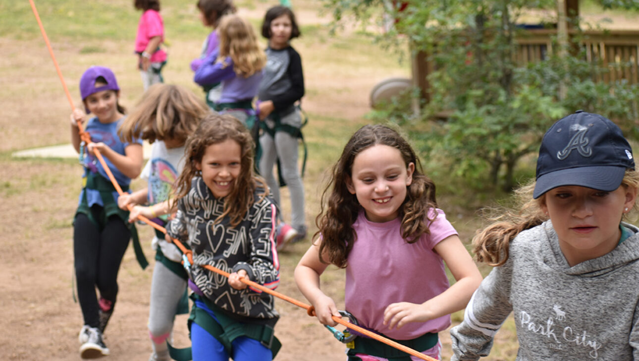 Campers doing a ropes course.