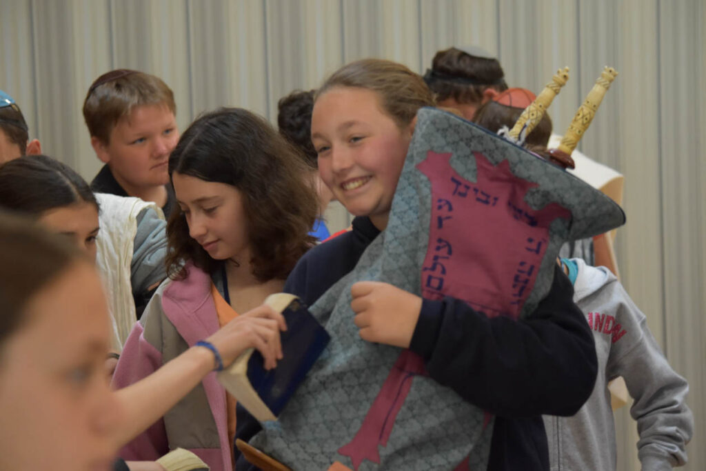 Campers carrying the torah.