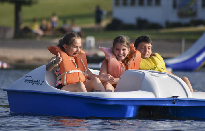Three campers on a paddle boat.