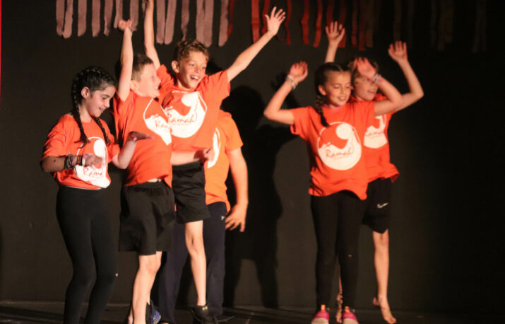 Campers dancing on stage.
