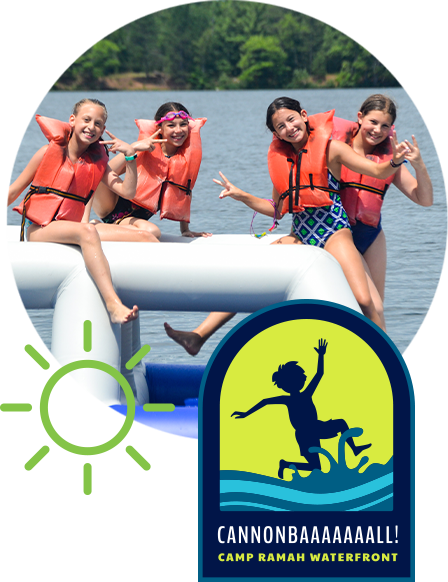 Campers in life vests having fun on the lake.
