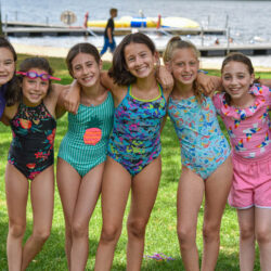 Campers in swim suits taking a group photo.