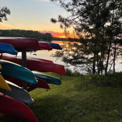 Kayaks on the lawn by the lake.