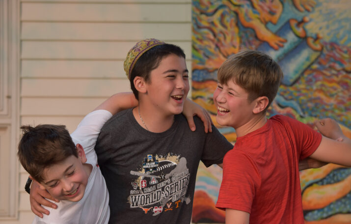 Three campers laughing together.