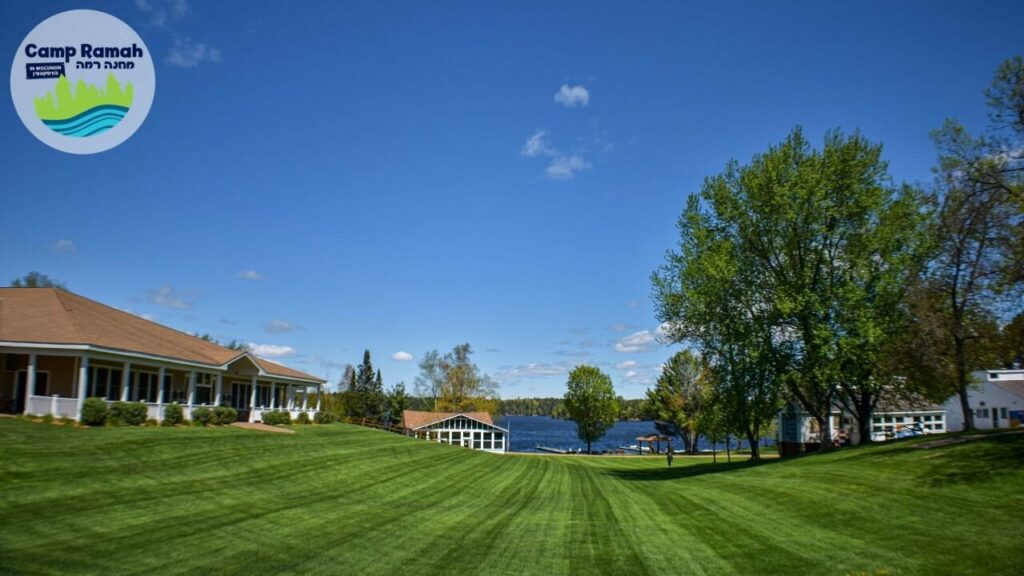 A large lawn with a view of a lake in the background.